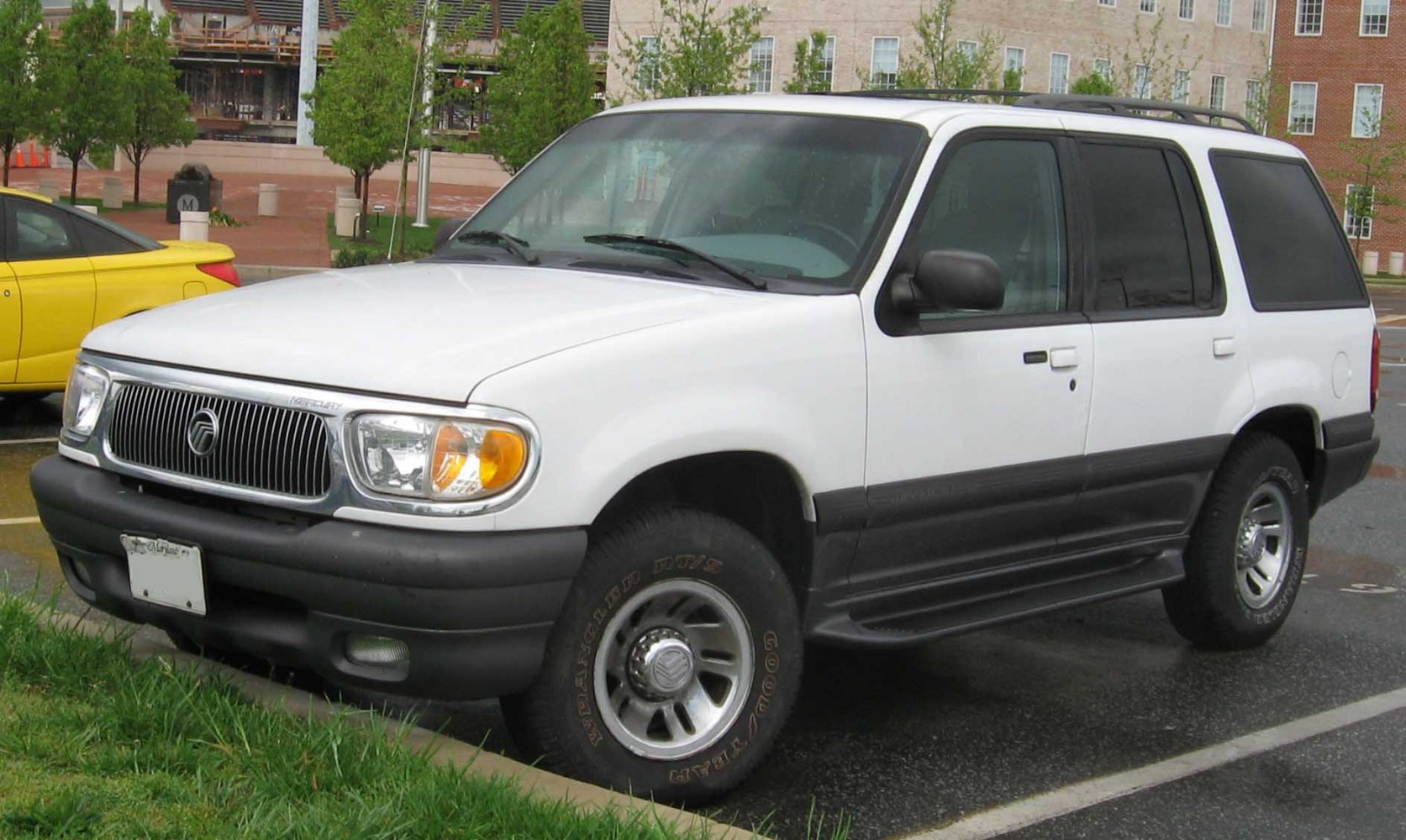 Front 3-4 view of a white SUV with distinctive grille and side steps