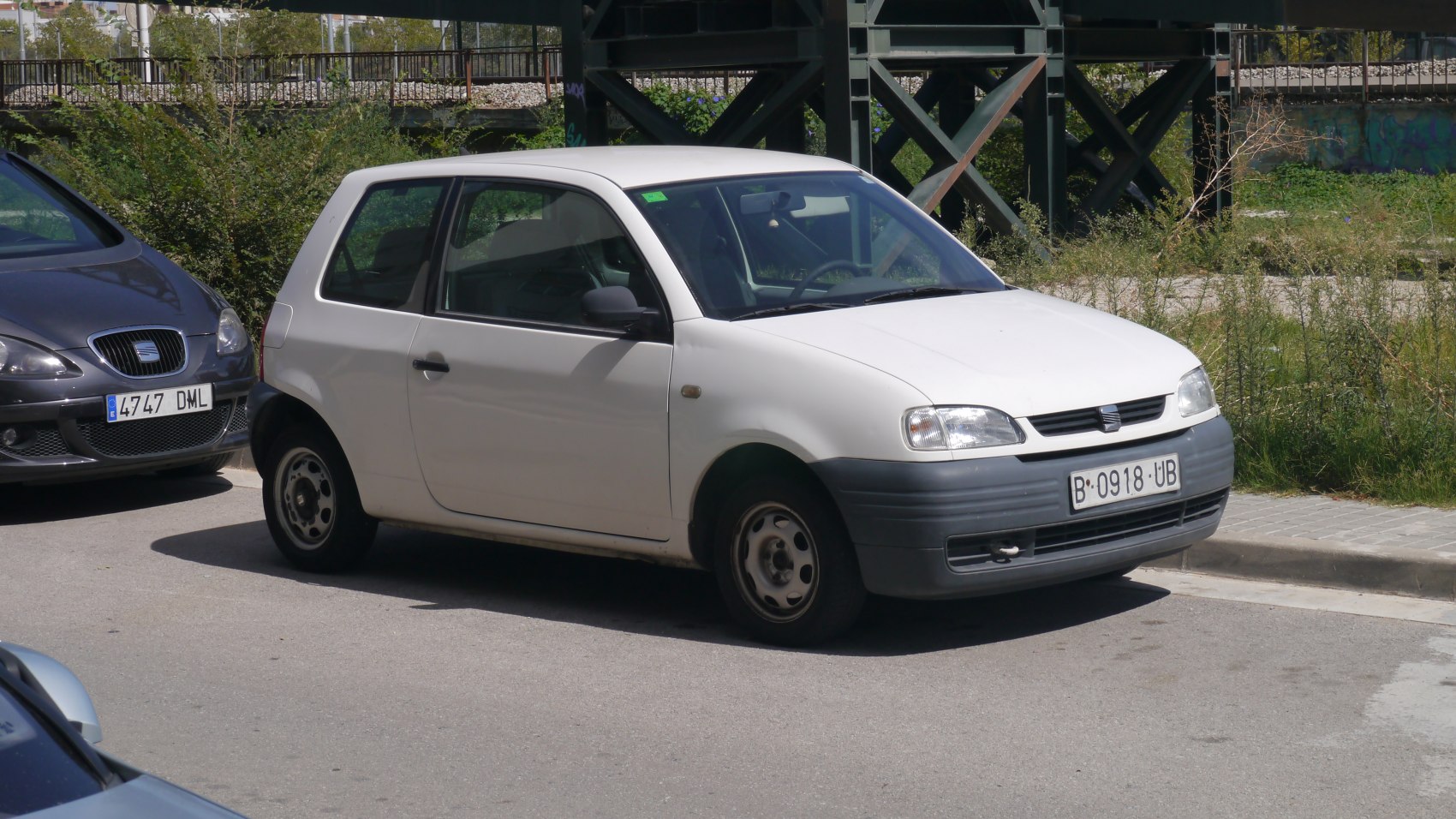 Compact white 3-door hatchback with steel wheels and black plastic bumpers