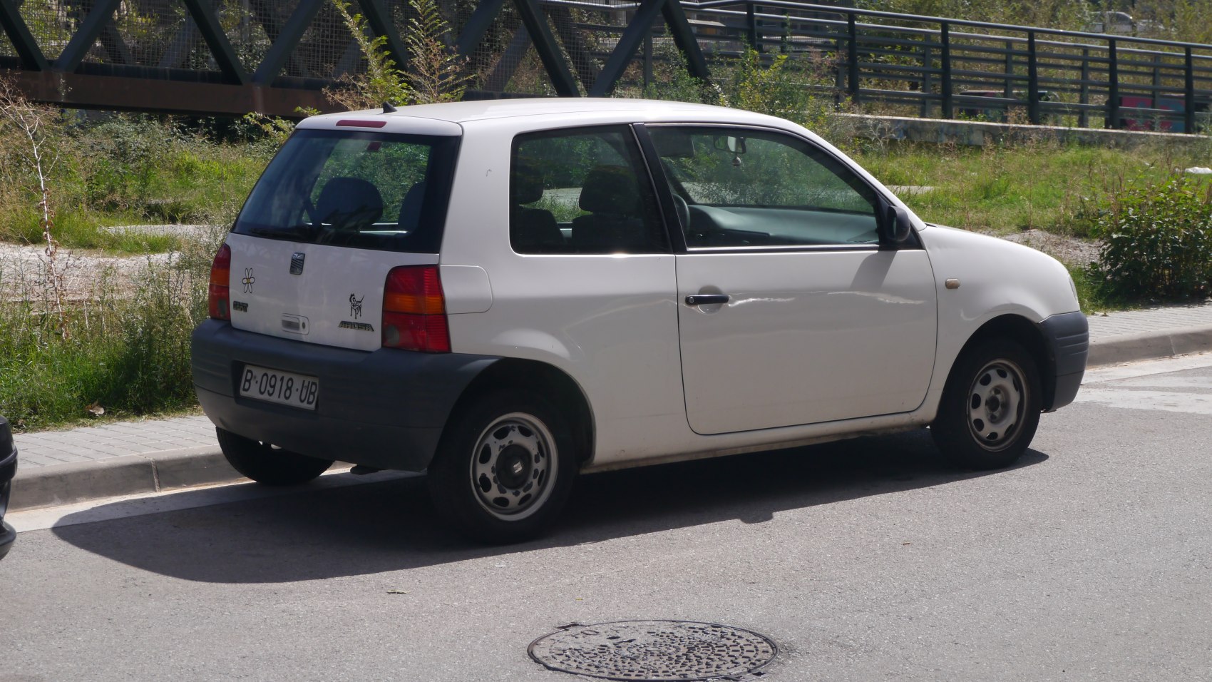Rear side view of compact hatchback with steel wheels
