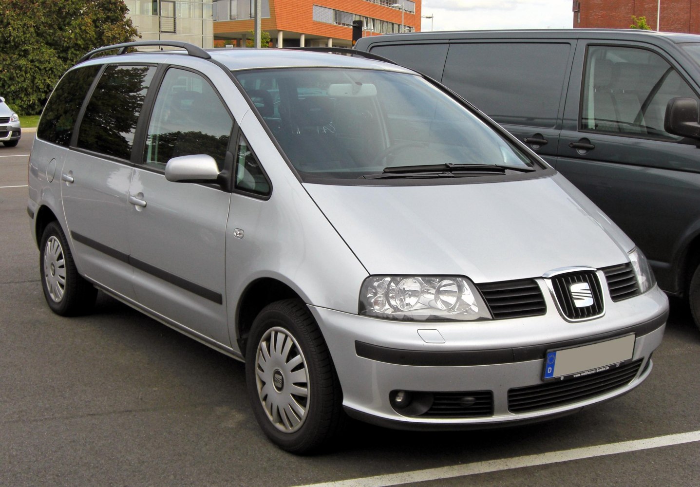Silver MPV with distinct front grille, headlights, and roof rails