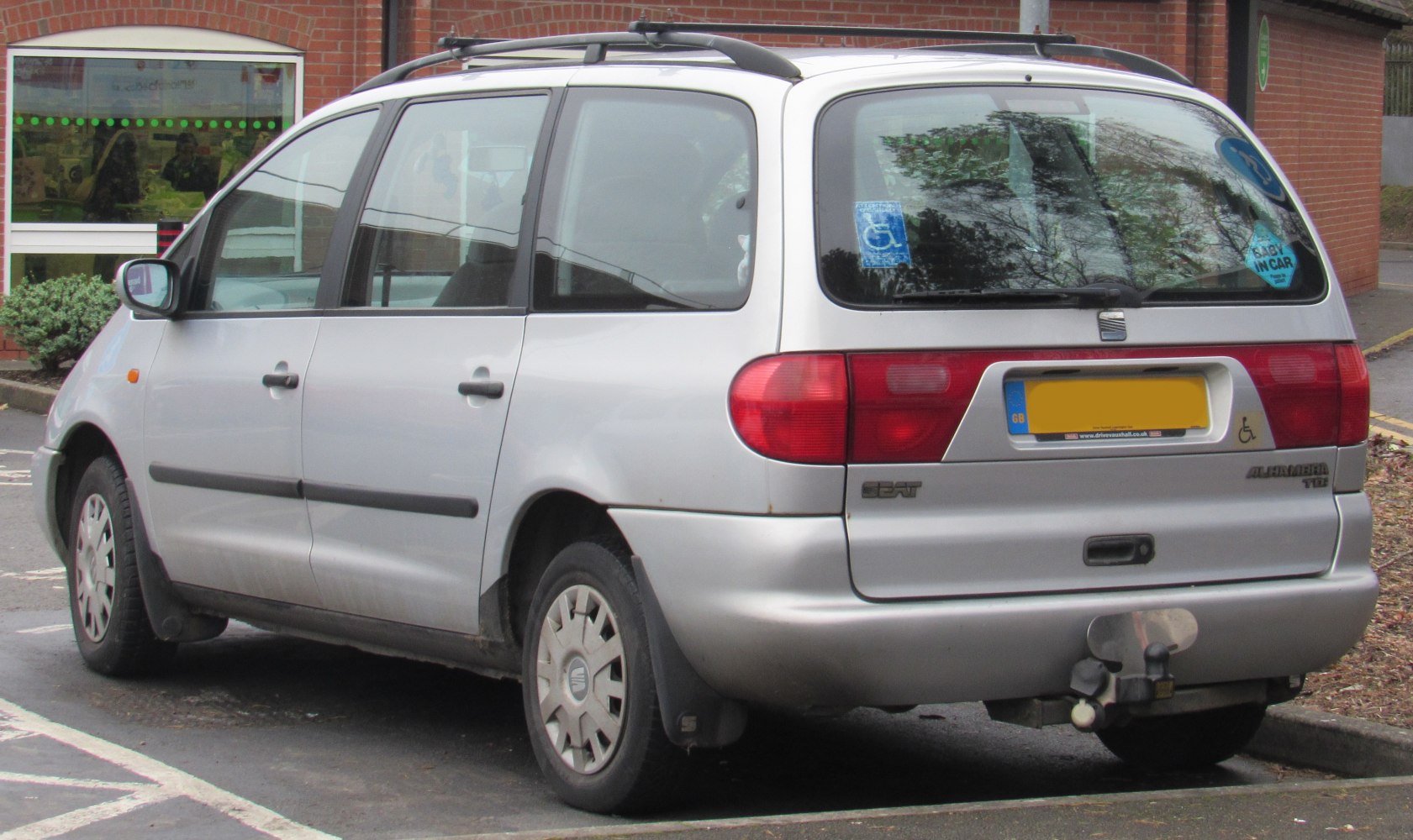 Minivan rear-side view with roof rails and tow hitch