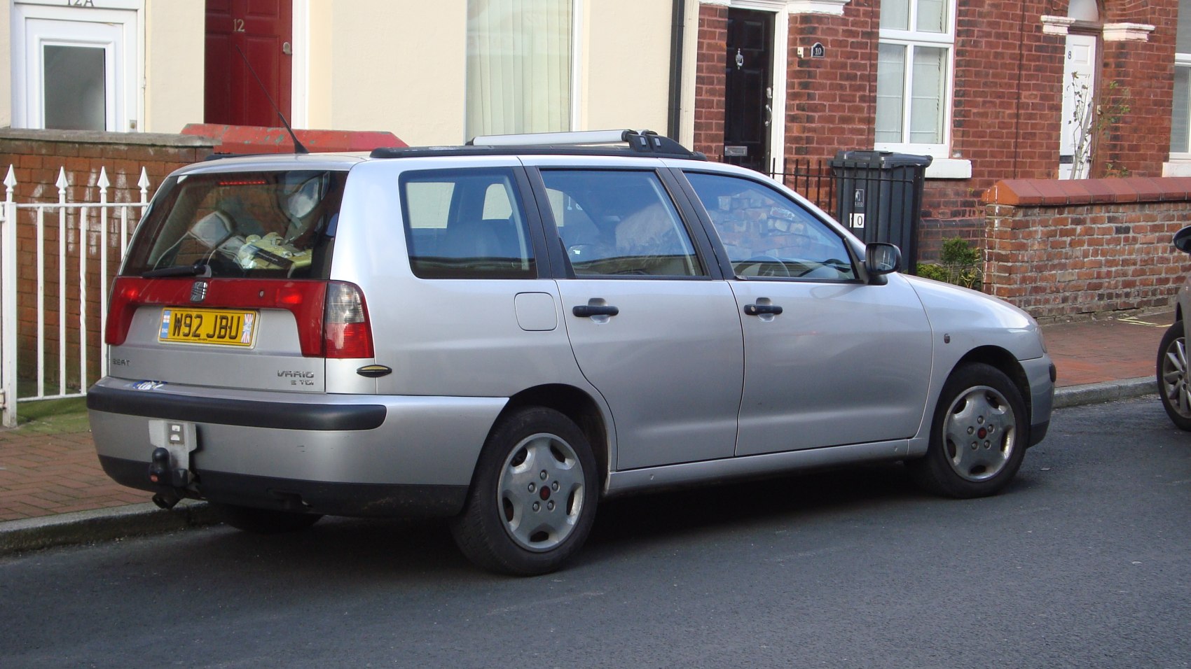 Silver compact station wagon with roof rails and tow hitch