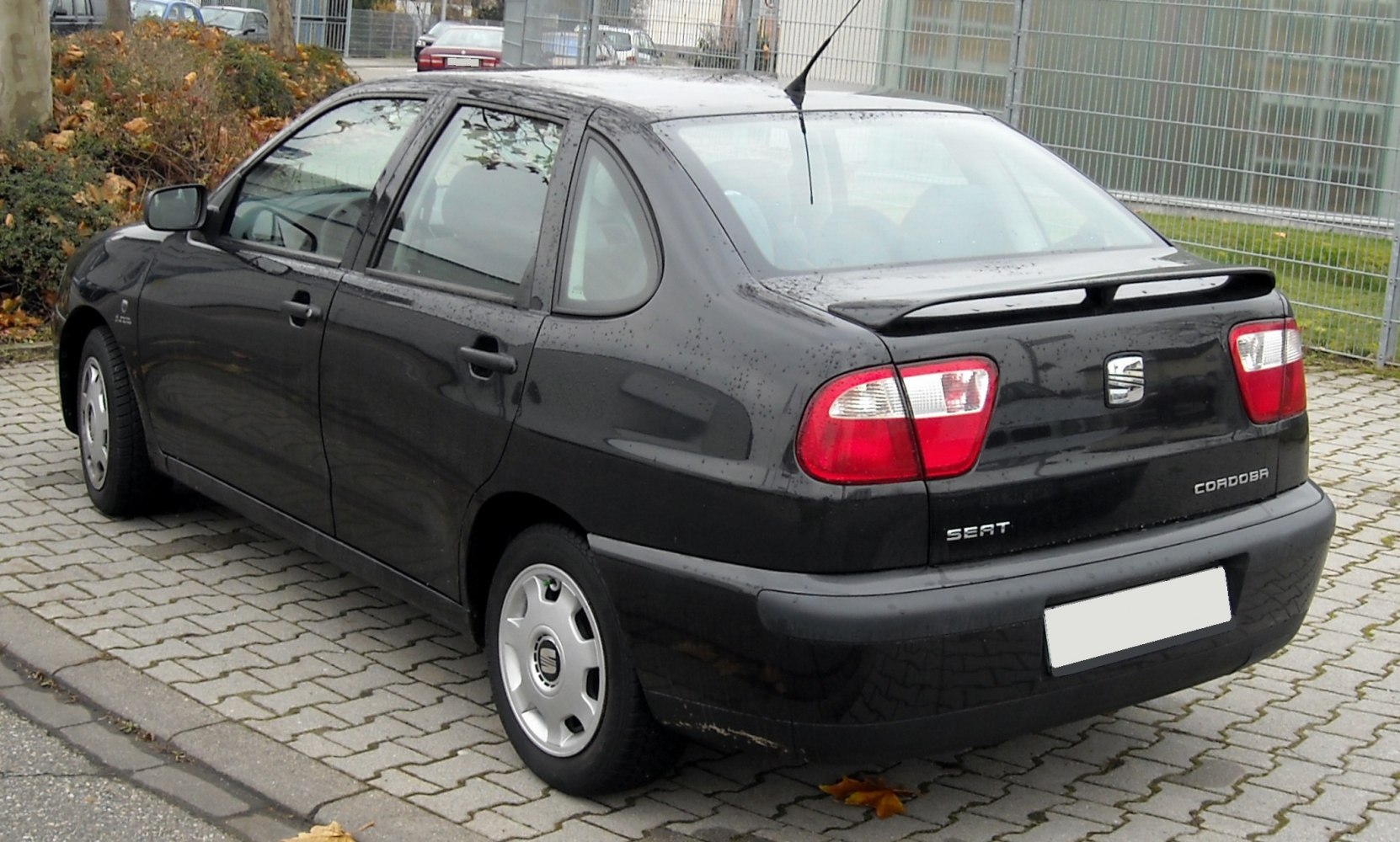Rear view with taillights and rear spoiler on compact sedan