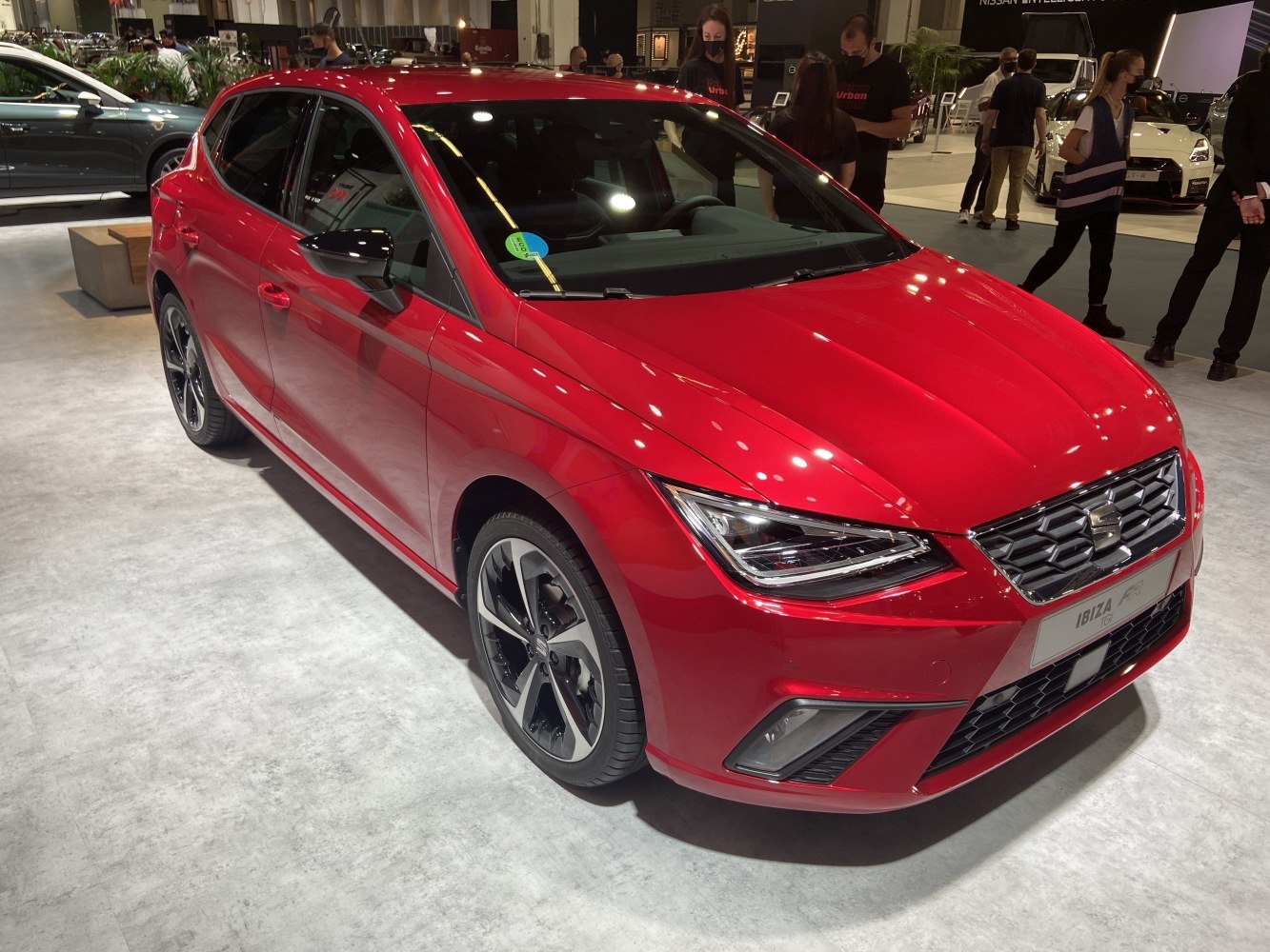 Front view of a red car with LED headlights and alloy wheels