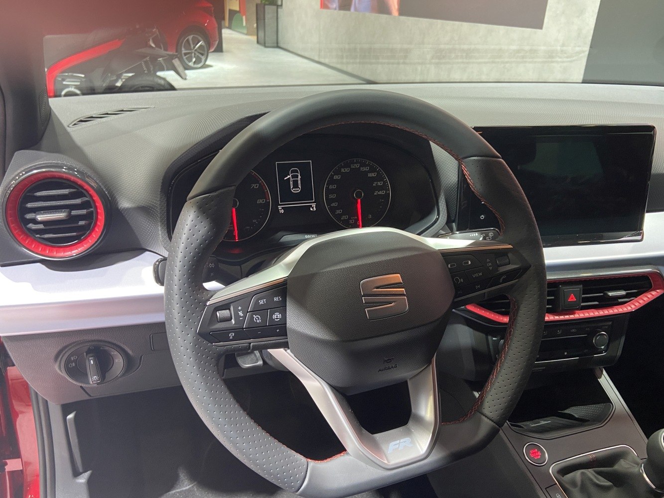Multifunction steering wheel with red accents and digital dashboard