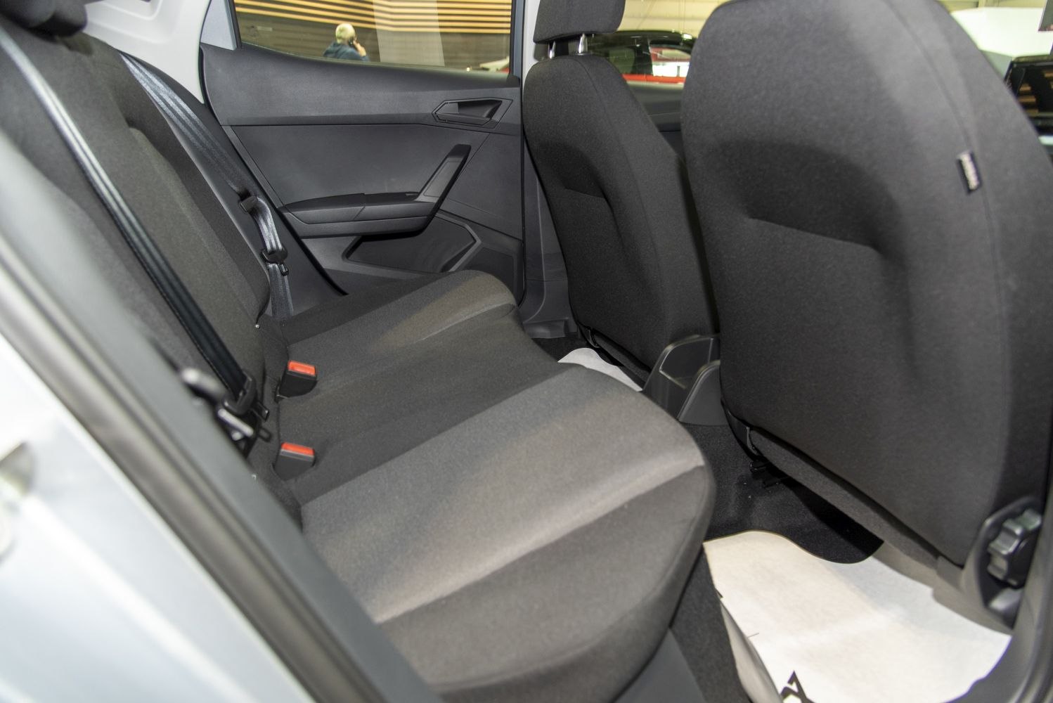 Rear passenger seating with fabric upholstery and door panel