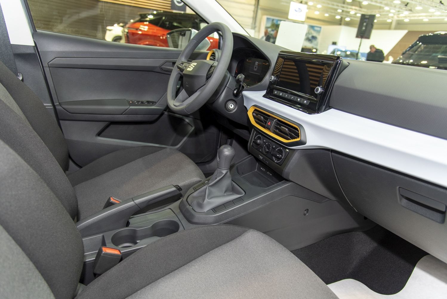 Modern car interior with touchscreen, gear stick, and dashboard controls