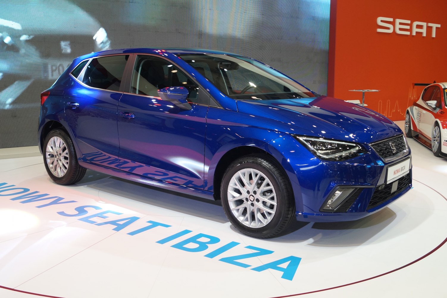 Blue compact hatchback with LED headlights and alloy wheels.
