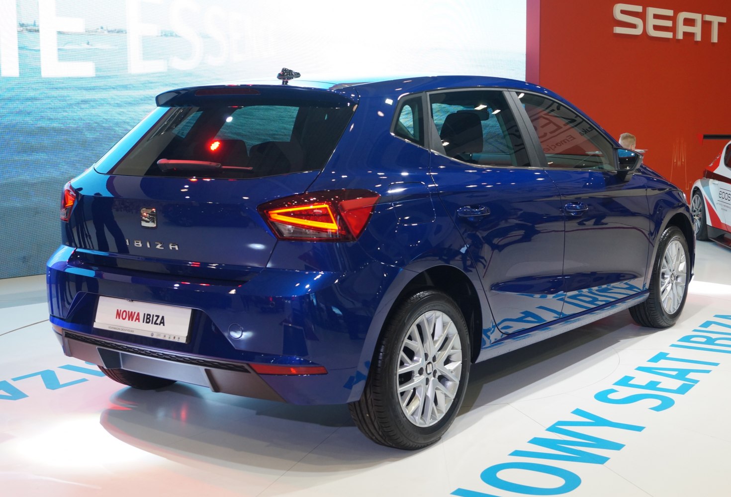 Blue hatchback rear-side view with distinct taillights and silver alloy wheels