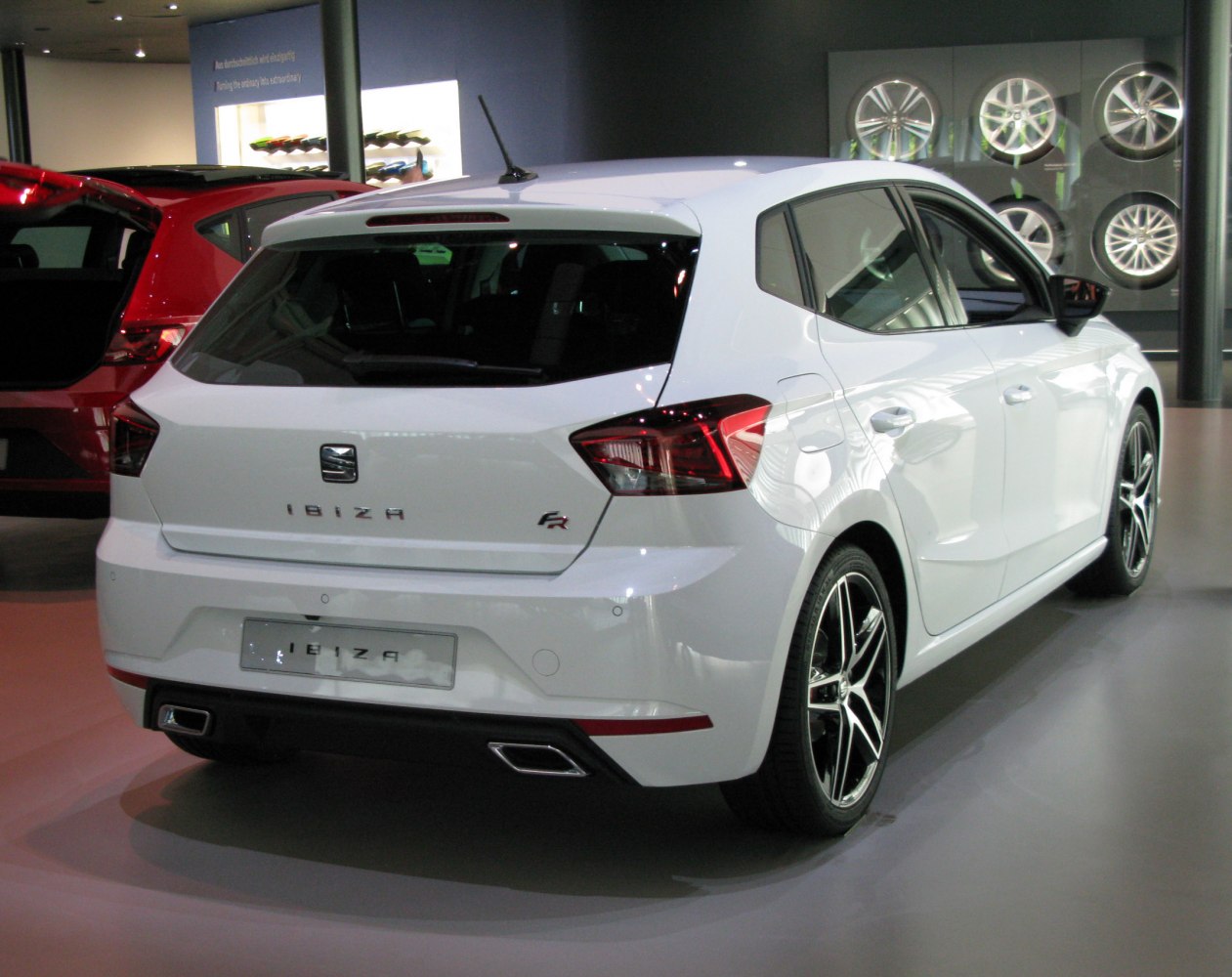 Rear hatchback view with dual exhaust outlets and alloy wheels