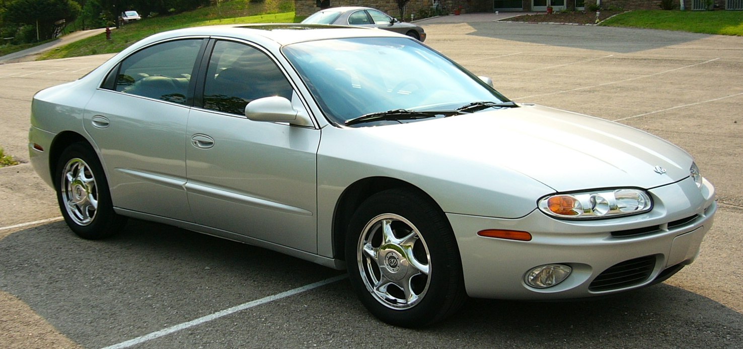 Silver sedan with aerodynamic body and chrome wheels