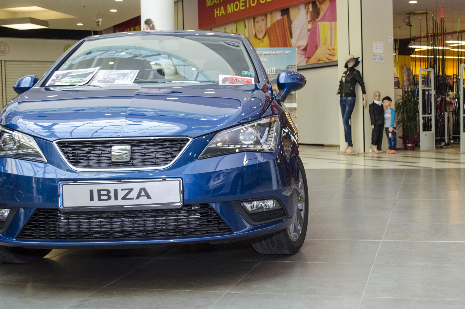 Close-up front view with grille and headlights of blue hatchback