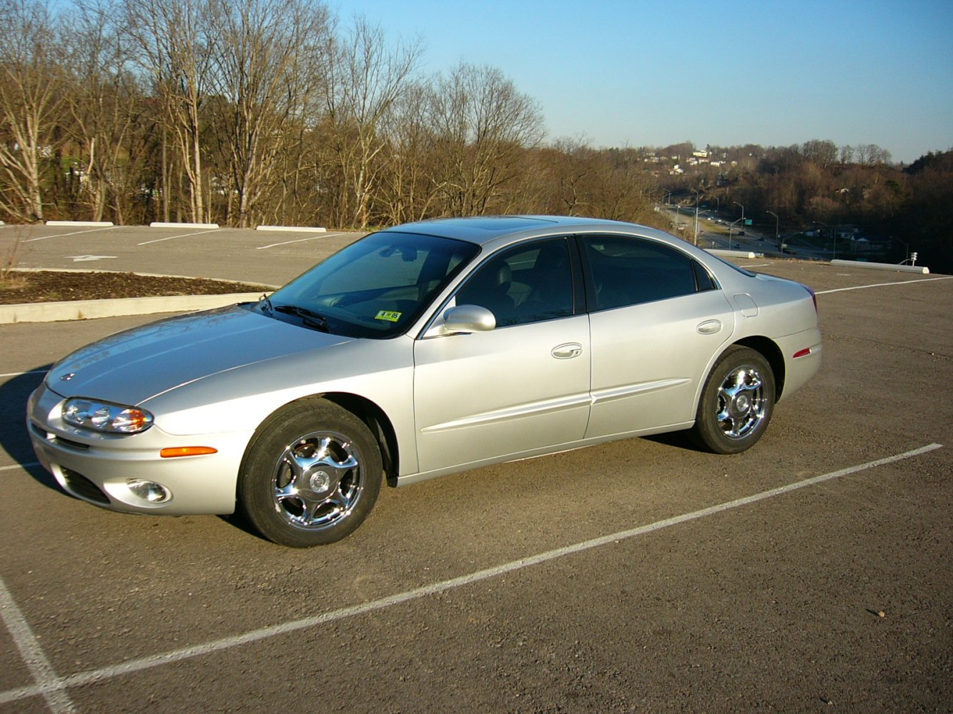 Mid-size silver sedan with smooth body lines and chrome wheels.