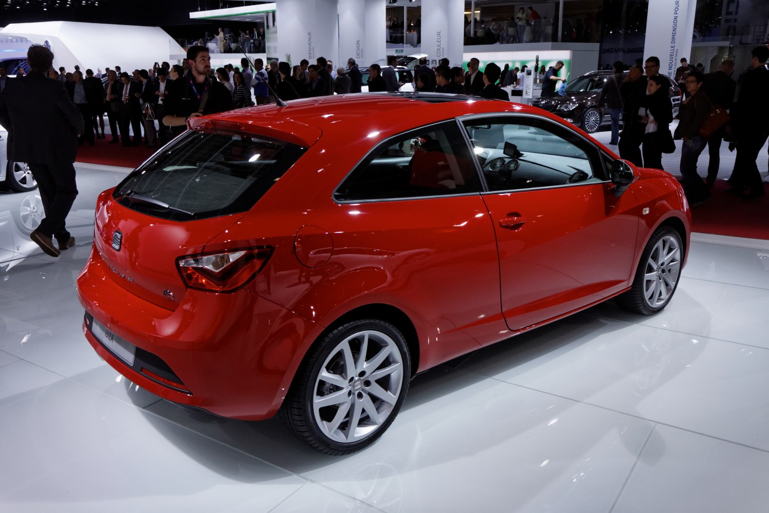 Red 3-door hatchback showcasing rear side with alloy wheels