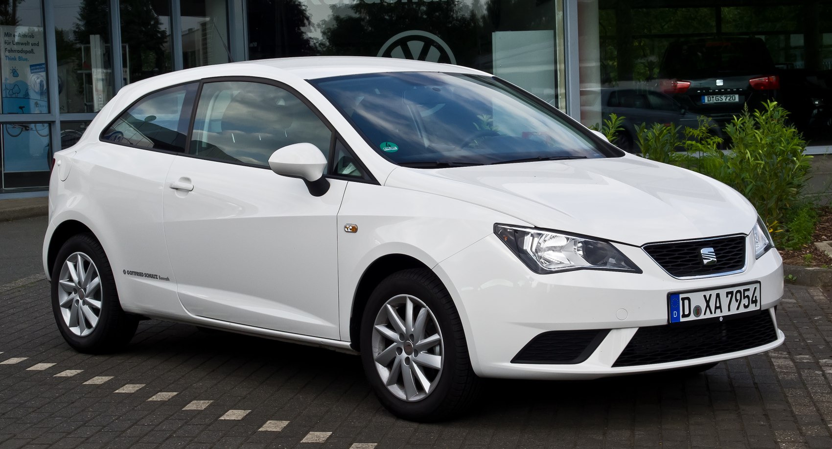 White small hatchback with sharp headlights and clean side profile