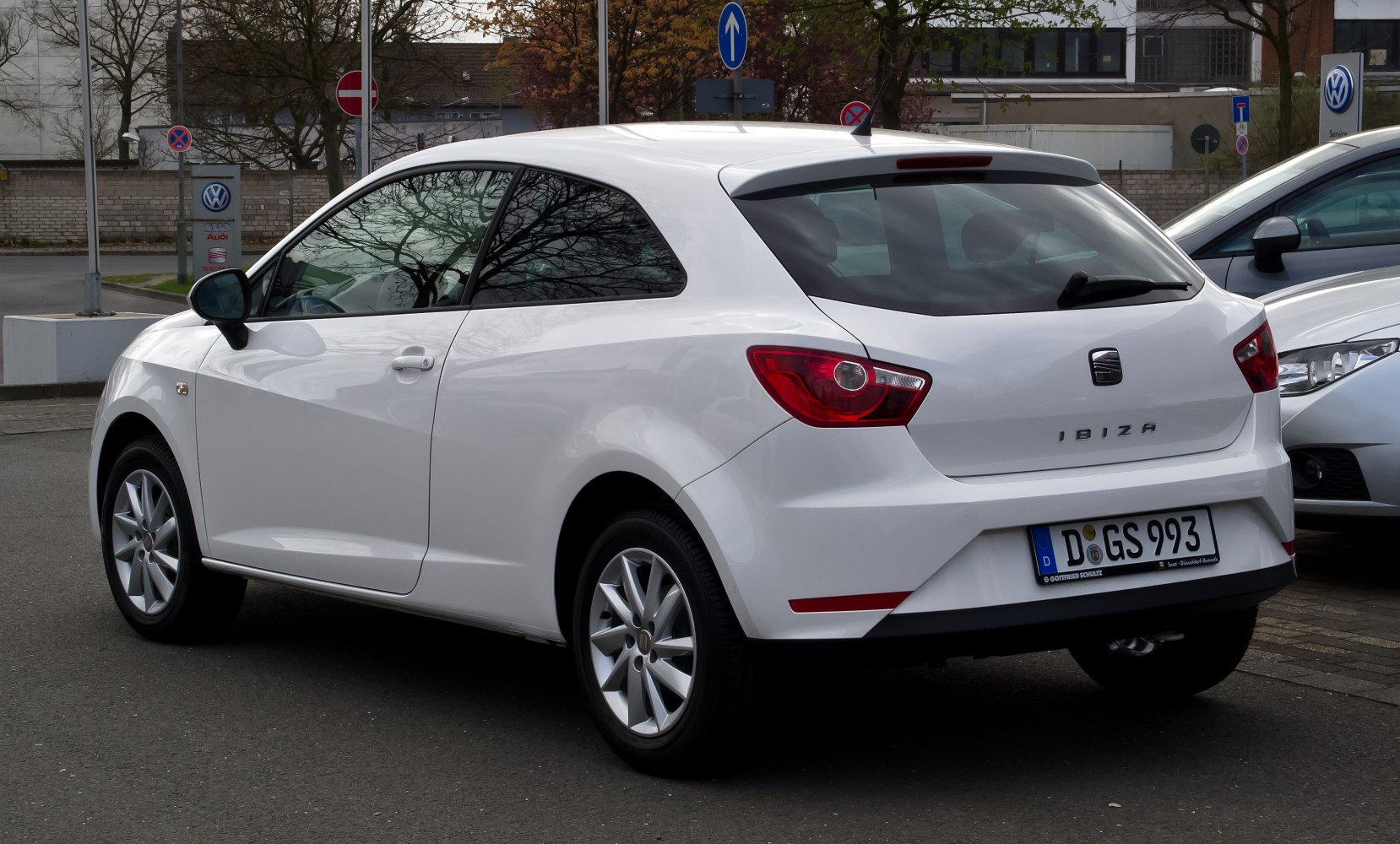 Rear side view of sporty hatchback with distinct taillights and white finish
