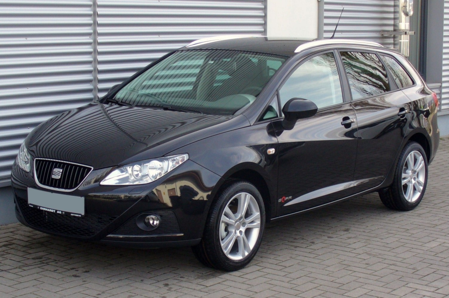 Sharp headlights and alloy wheels on a compact station wagon