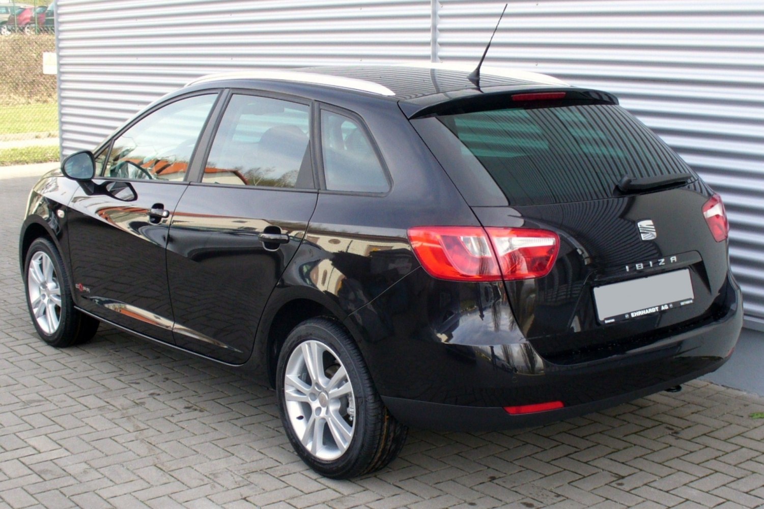 Rear and side profile of black compact station wagon