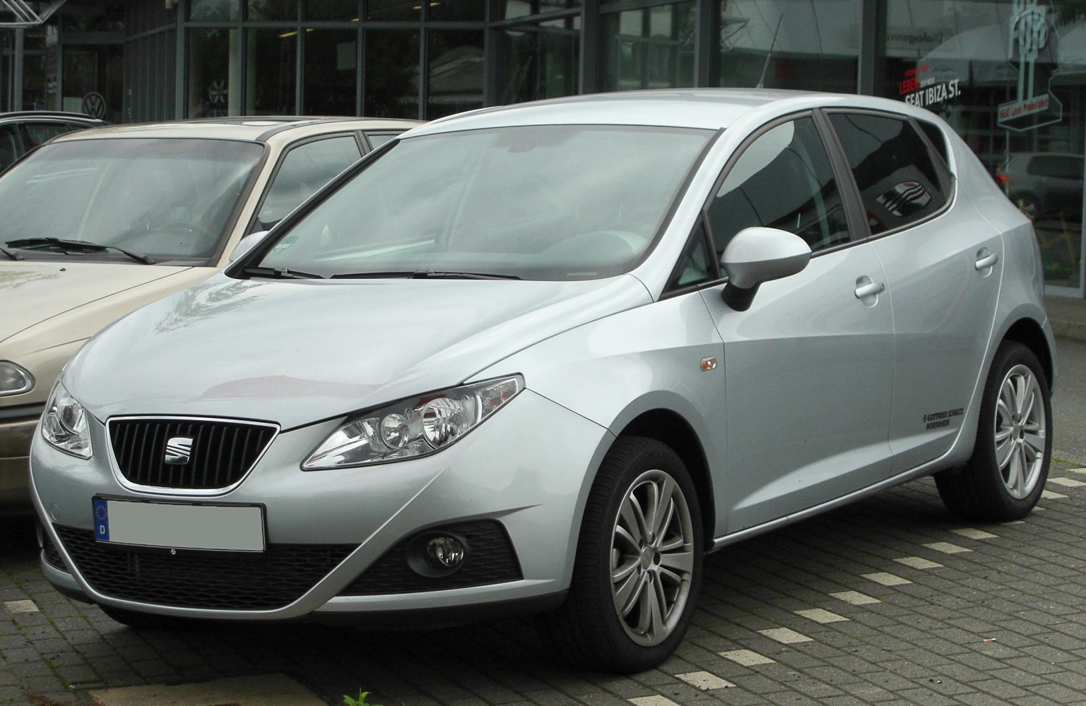 Front-side view of compact hatchback with angular headlights and alloy wheels