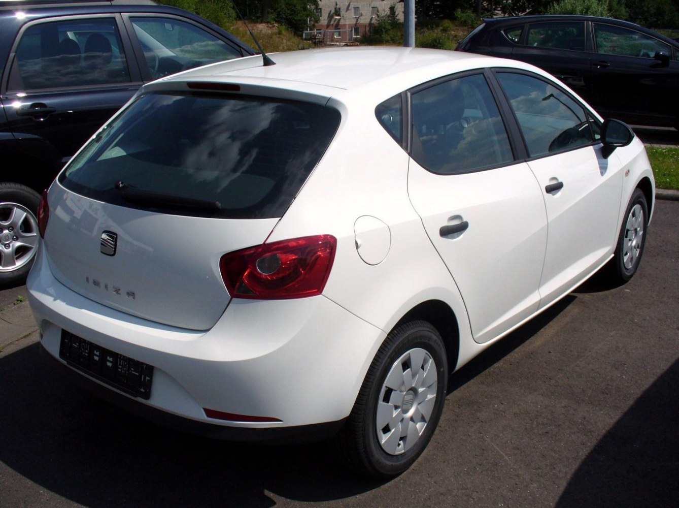 White hatchback rear three-quarter view with distinct tail lights and rear window shape