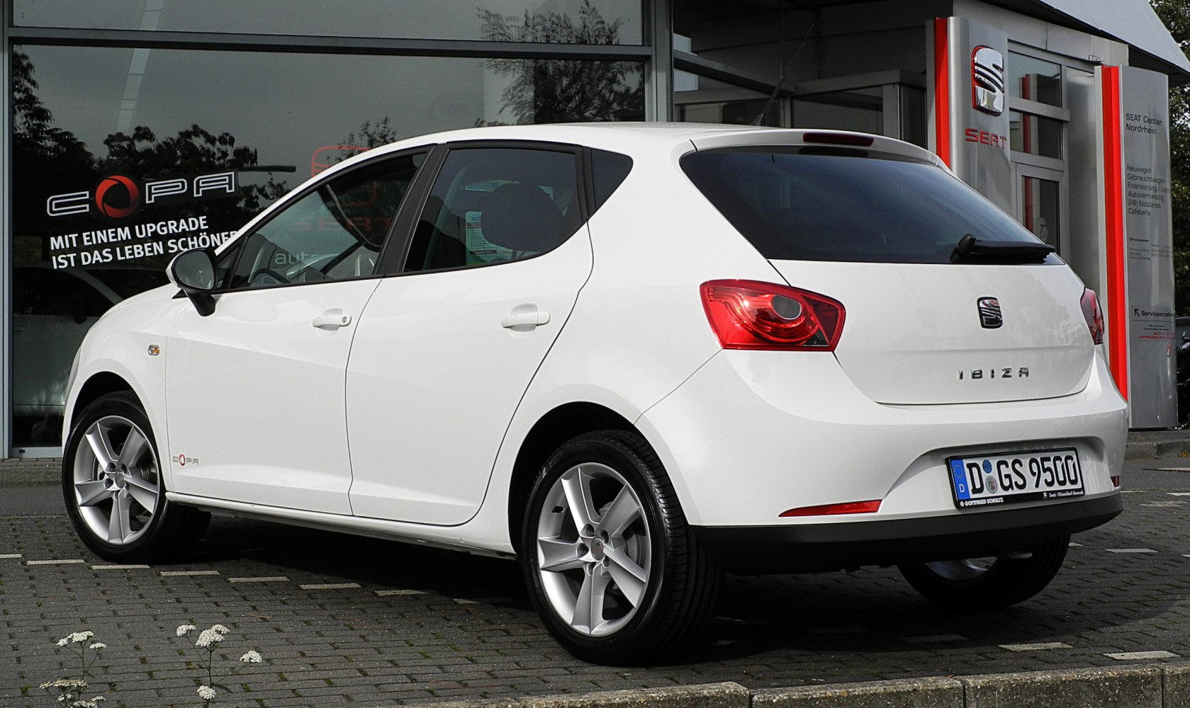White five-door hatchback rear and side view with tinted windows and alloy wheels
