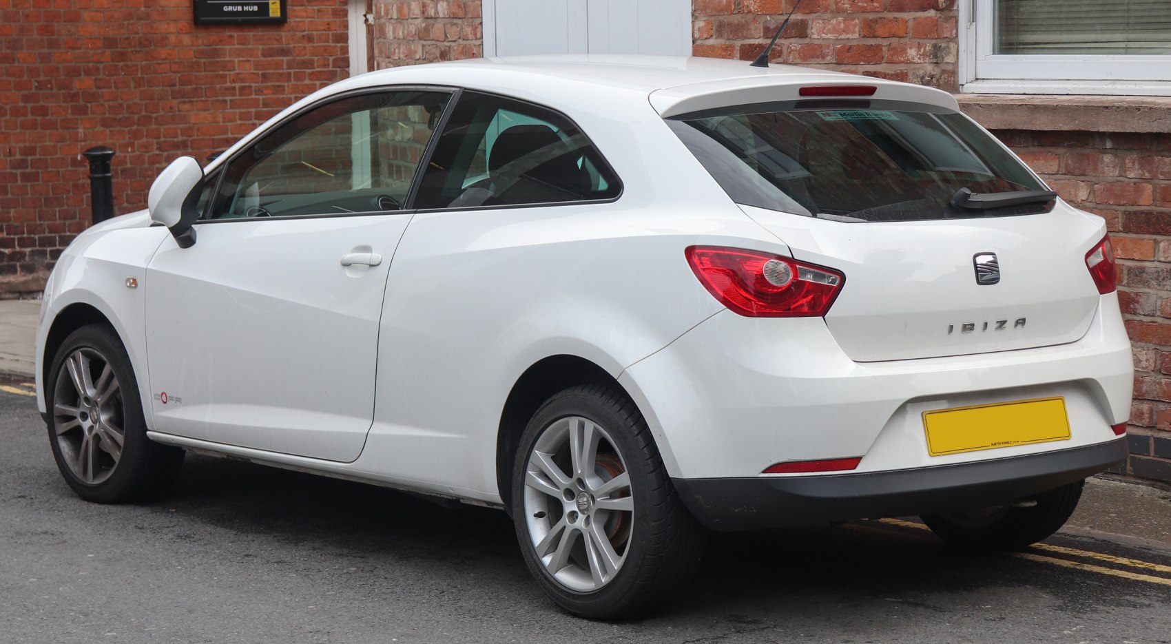 Sporty two-door hatchback rear and side view with distinctive rear lights.