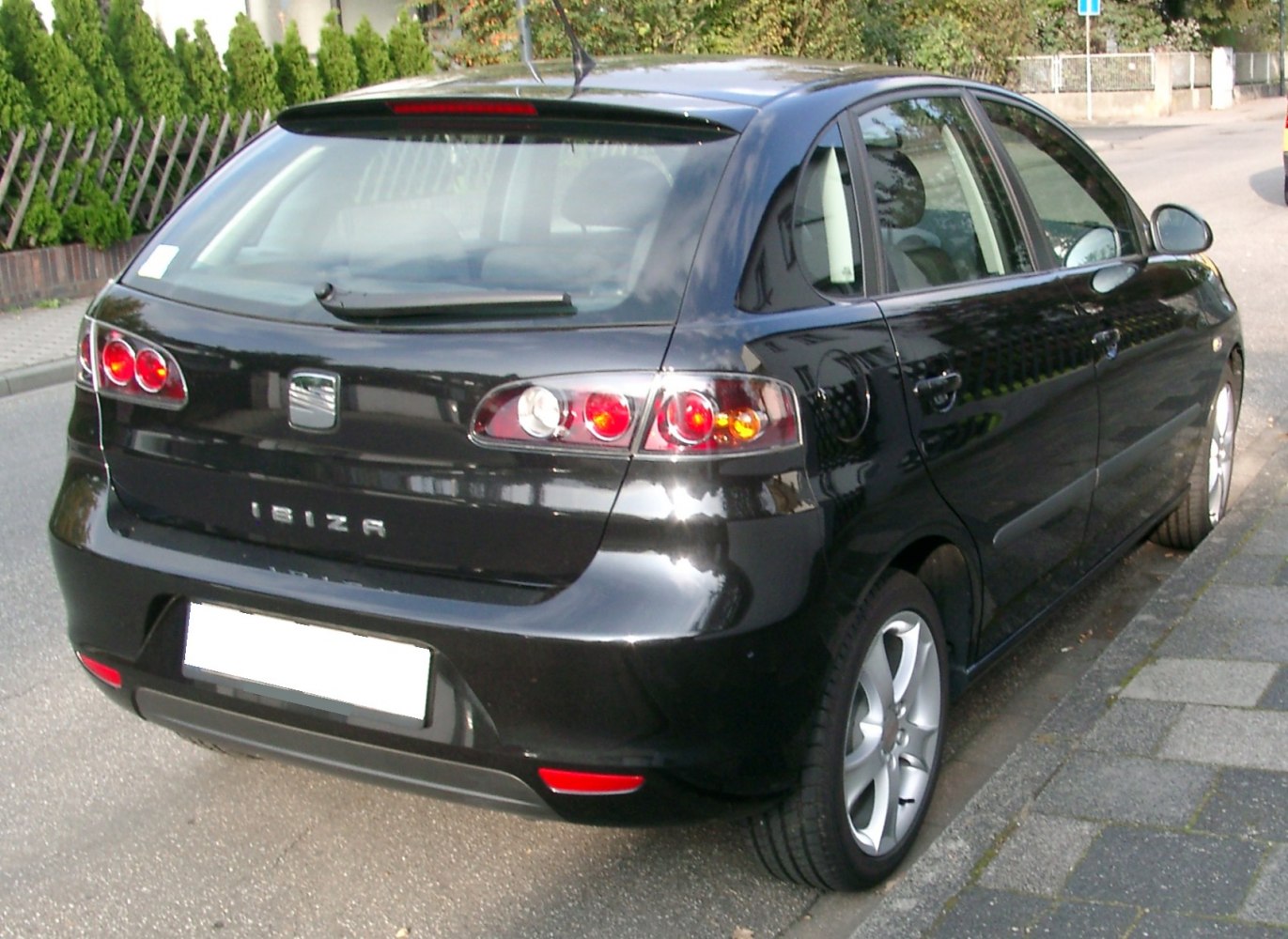 Rear hatchback view with distinctive tail light design and rear window wiper