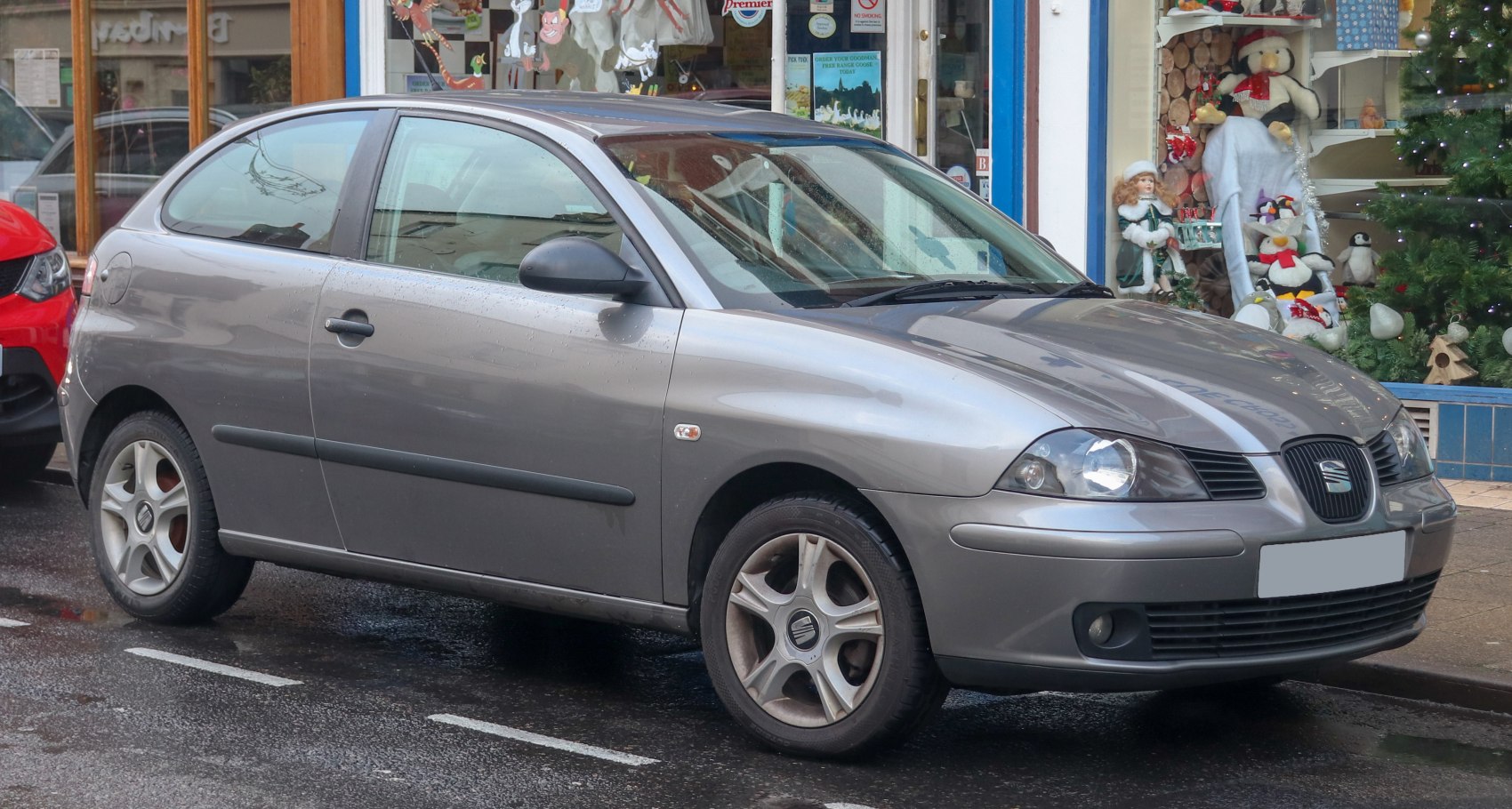 Silver compact hatchback with distinctive headlights and alloy wheels.
