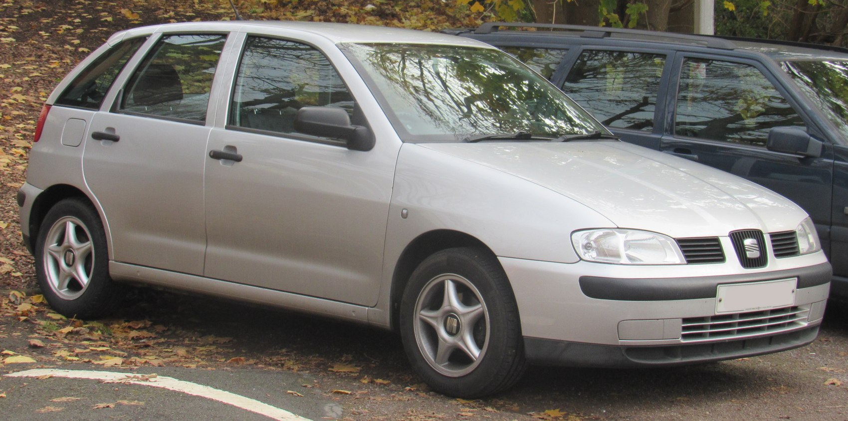 Silver 5-door hatchback with alloy wheels parked on a leafy street