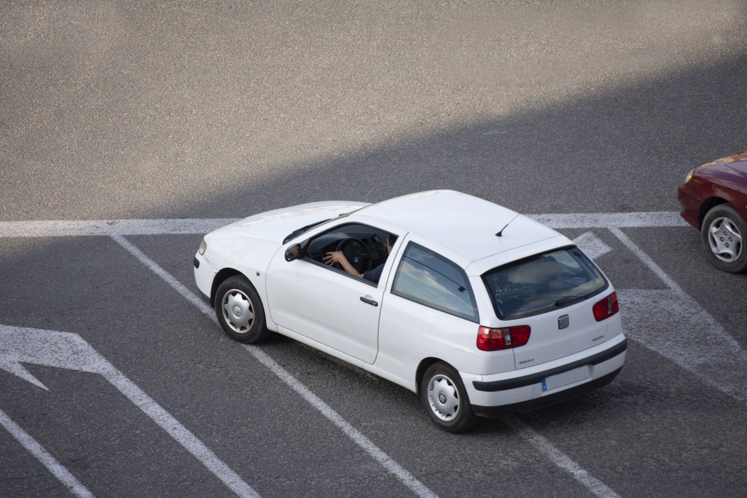 Rear three-quarter view of white compact hatchback with black bumper and distinct rear lights