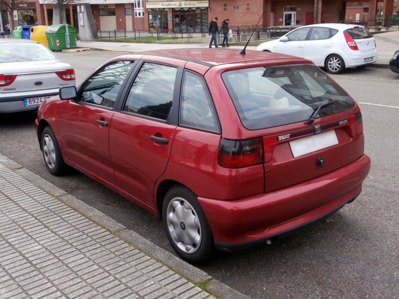 Rear side view of a compact five-door hatchback with tinted taillights.