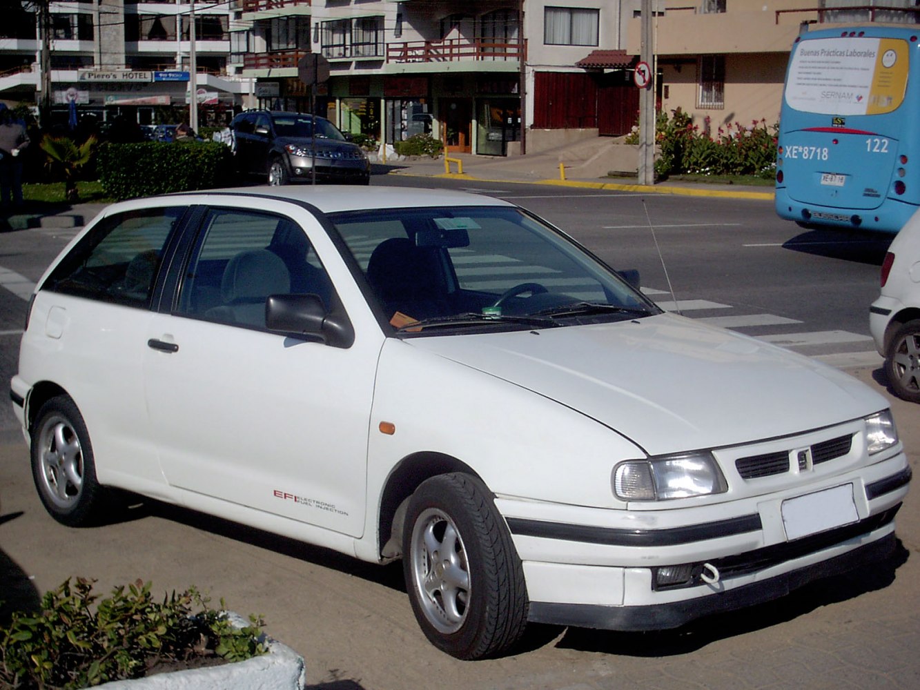 White 1990s compact hatchback with EFI badge and black trim details