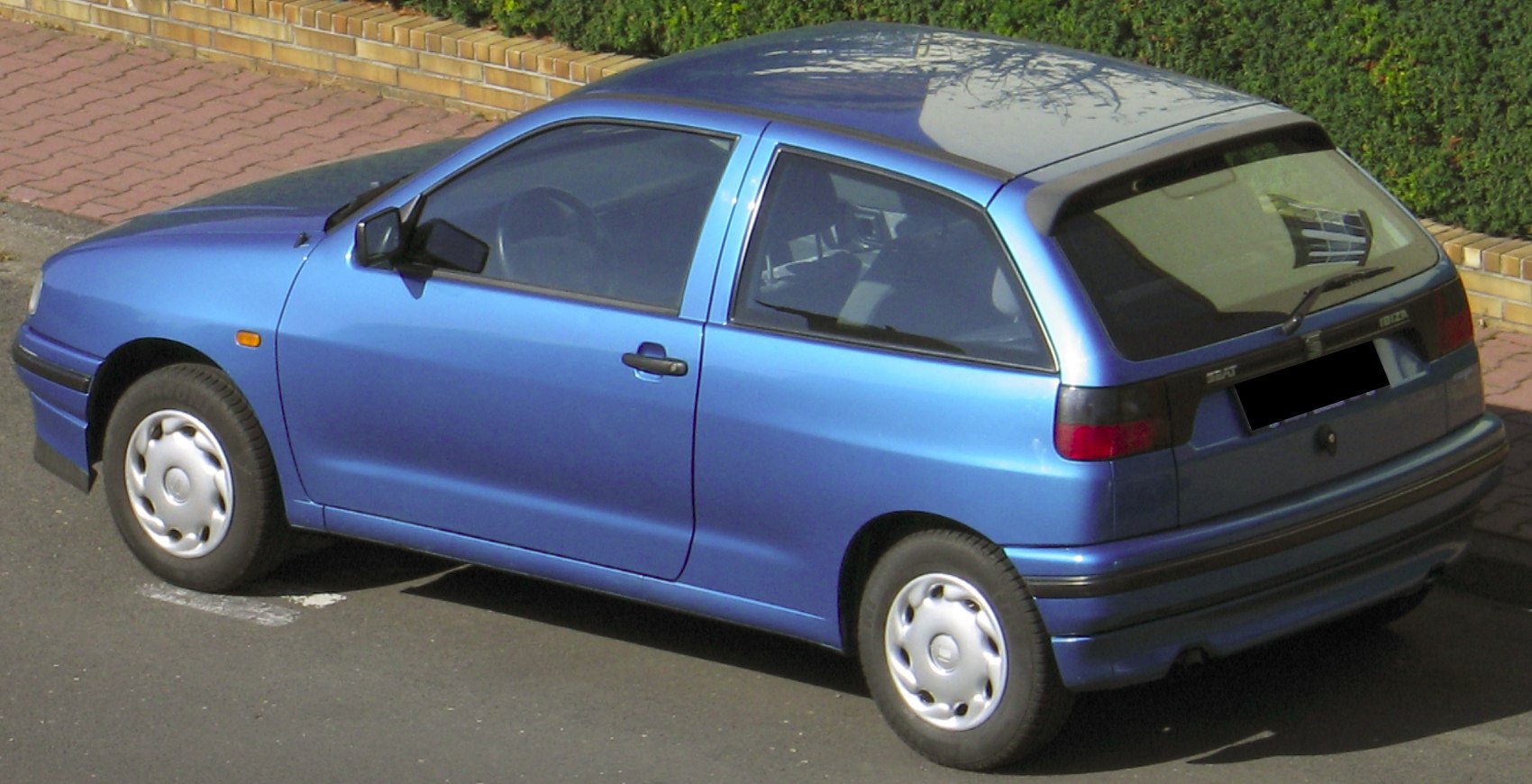 3-door compact hatchback with rear spoiler and hubcaps