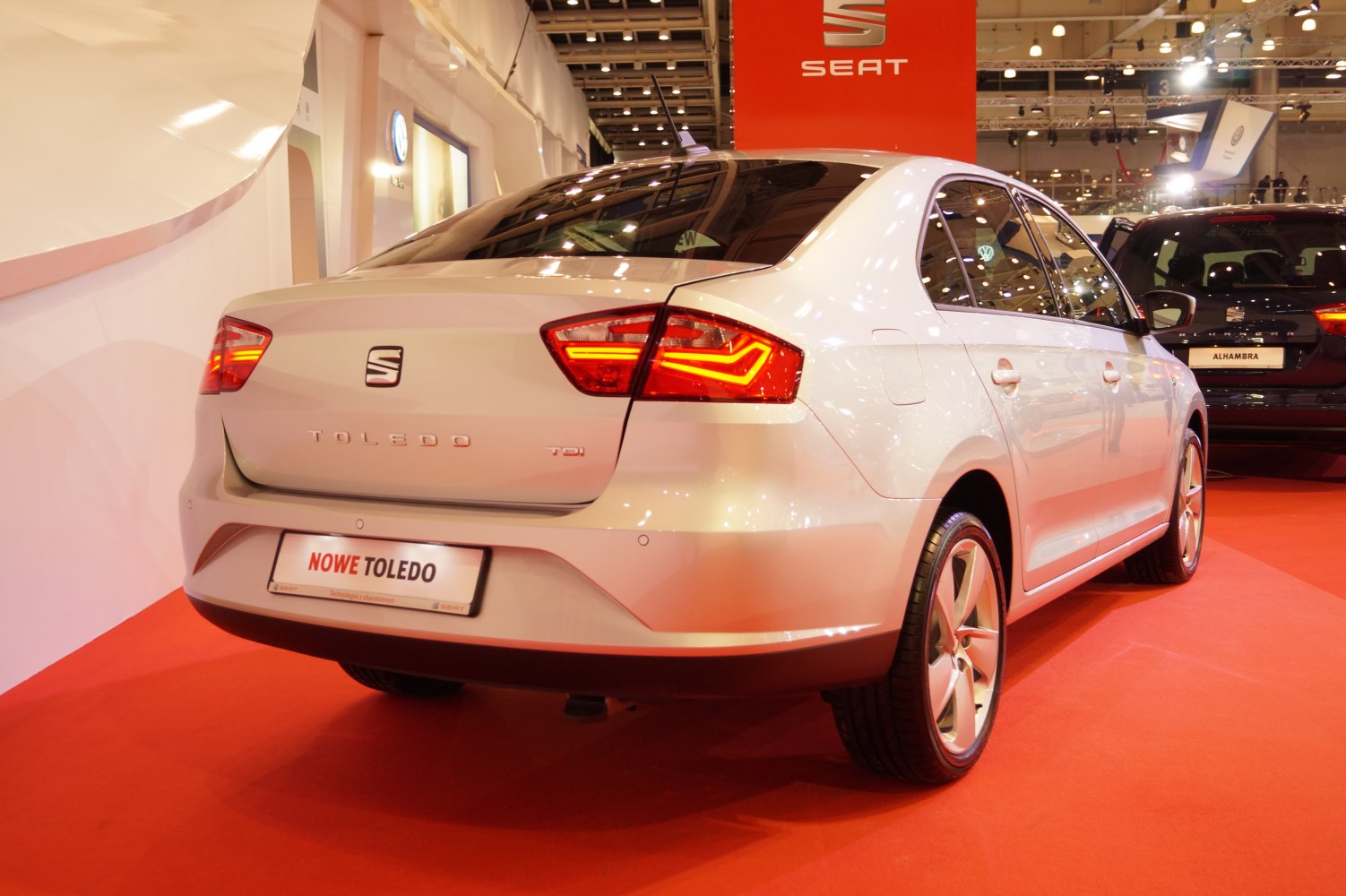 Rear view of a sedan with illuminated taillights and a smooth, aerodynamic design