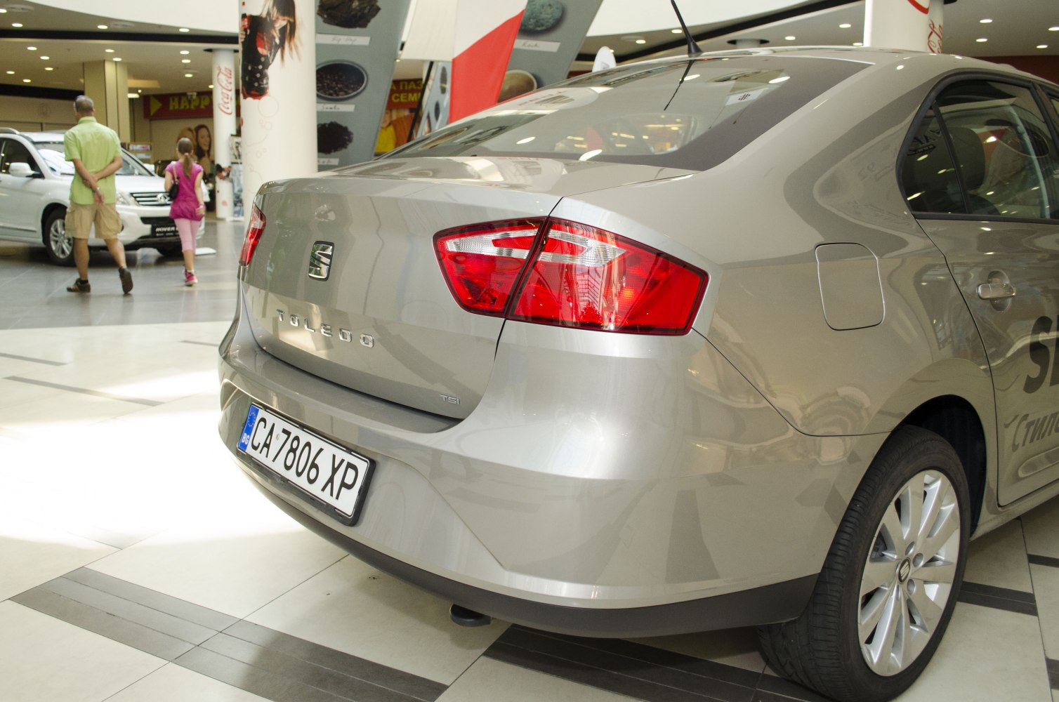 Rear sedan view with distinctive tail lights and alloy wheels