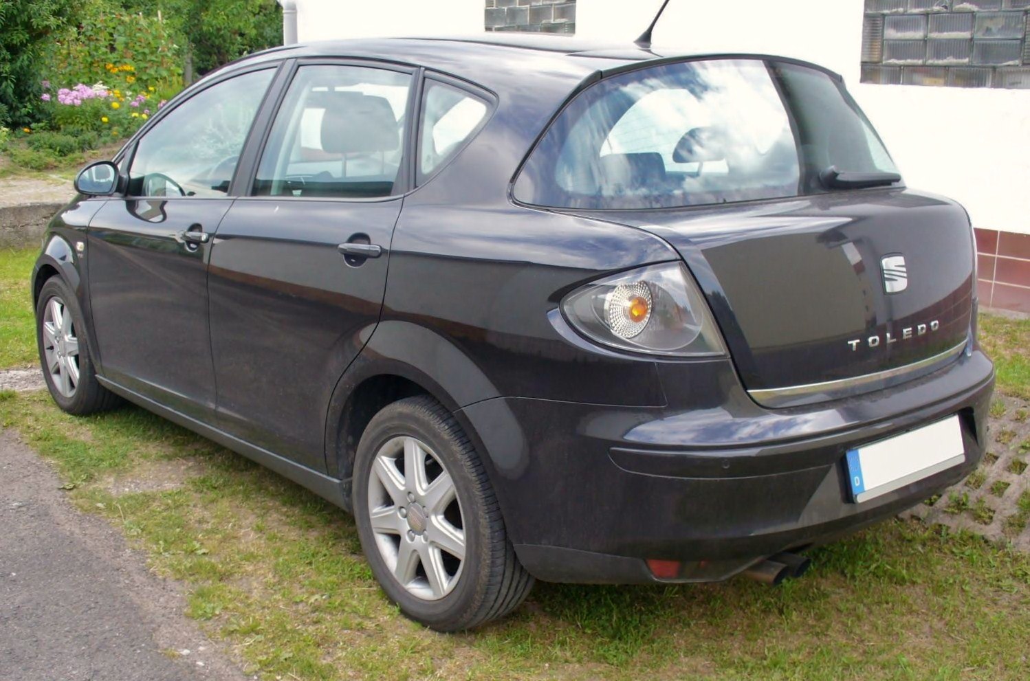 Rear side view of a black hatchback with distinctive tail lights and alloy wheels