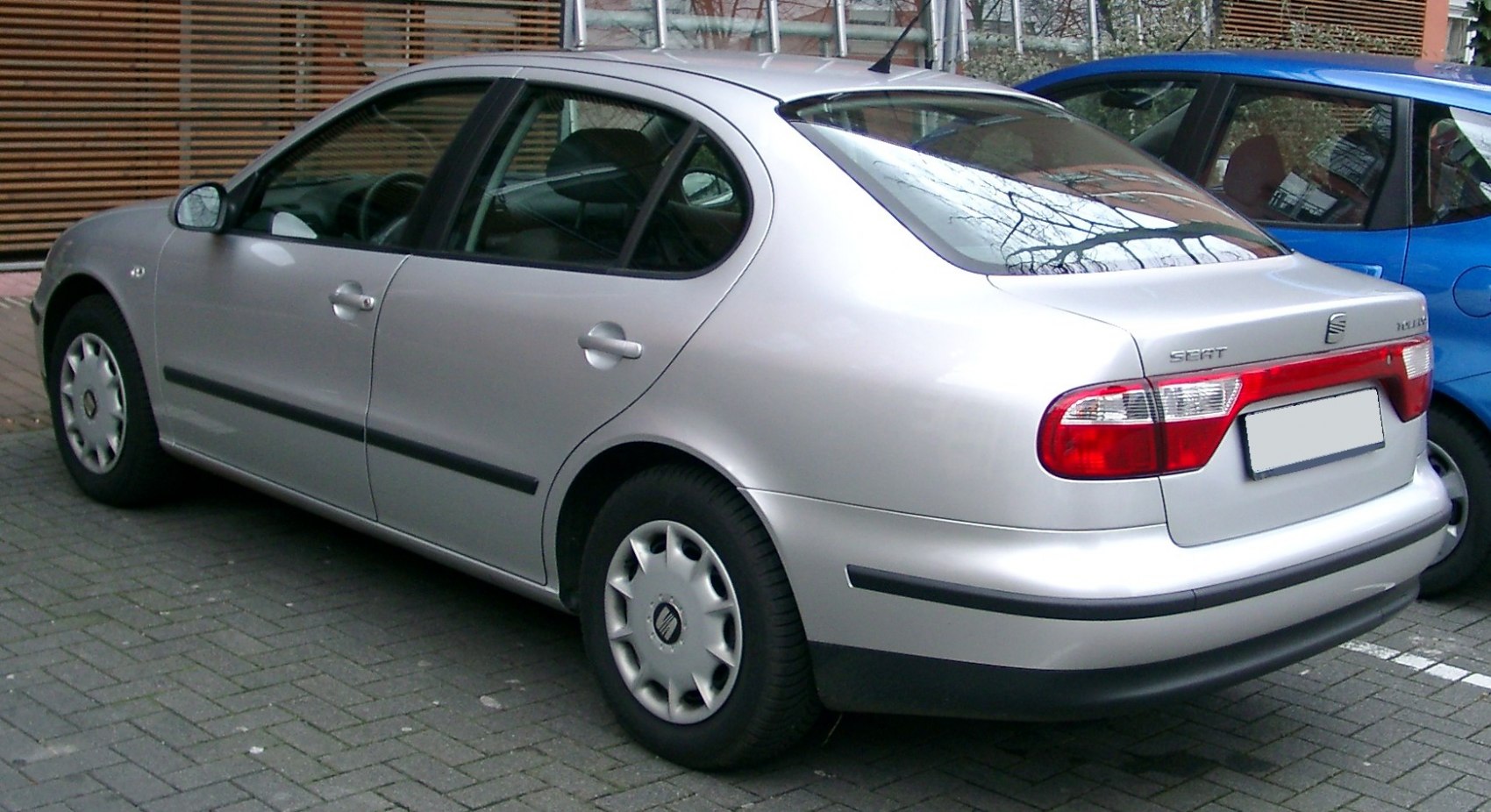 Rear-side view of silver sedan with distinct taillights and black trim