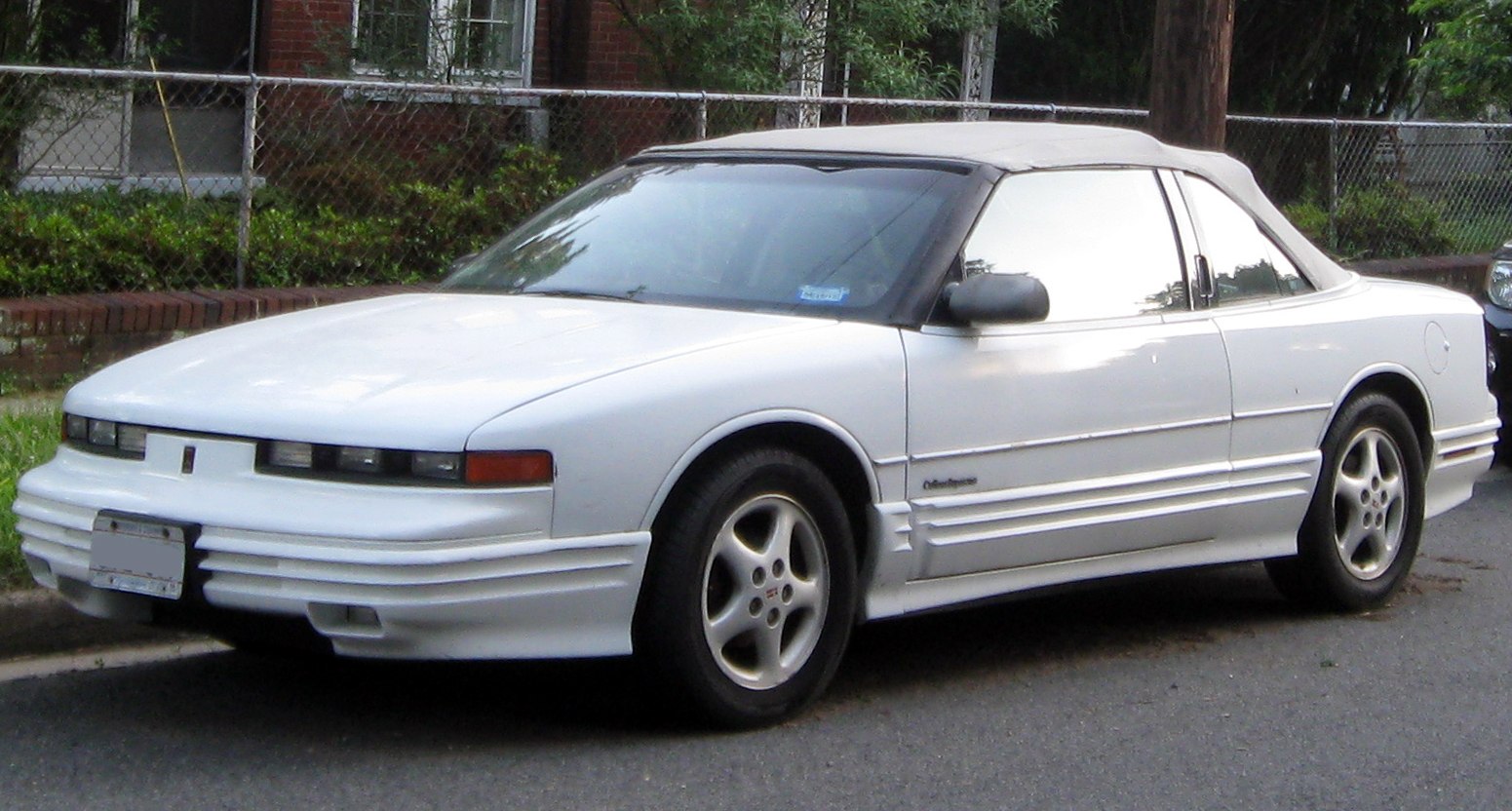White convertible with soft top roof and distinctive front design