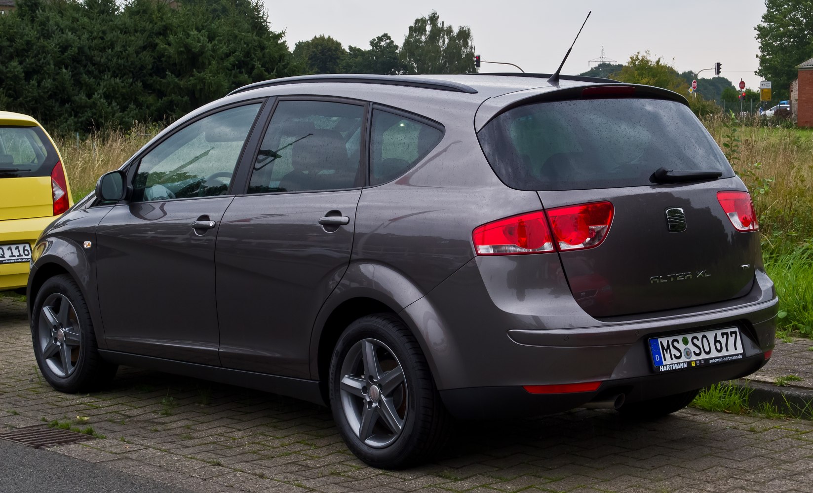 Rear-side view with tail lights, roof rails, and alloy wheels