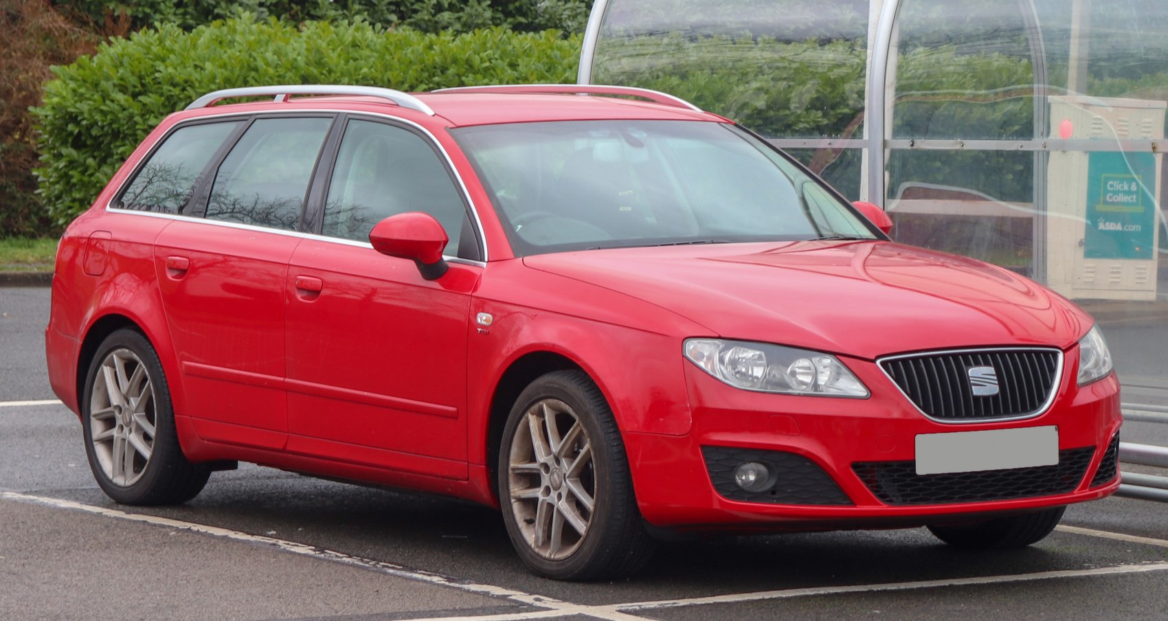 Red station wagon with alloy wheels and front grille
