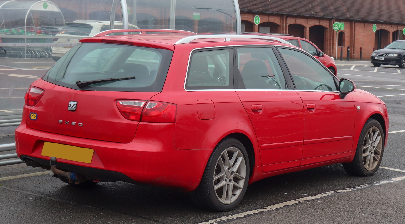 Rear view of red wagon with distinctive taillights and roof rails