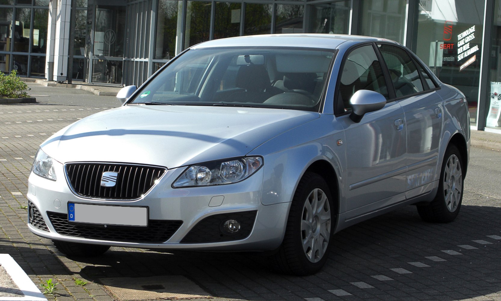 Sedan front with chrome vertical grille and silver side mirrors
