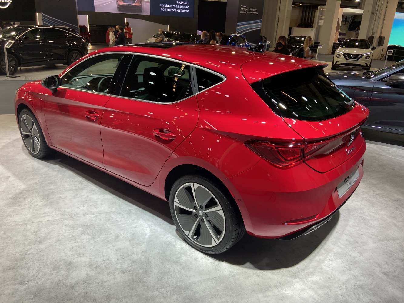 Red hatchback with sleek taillights and alloy wheels