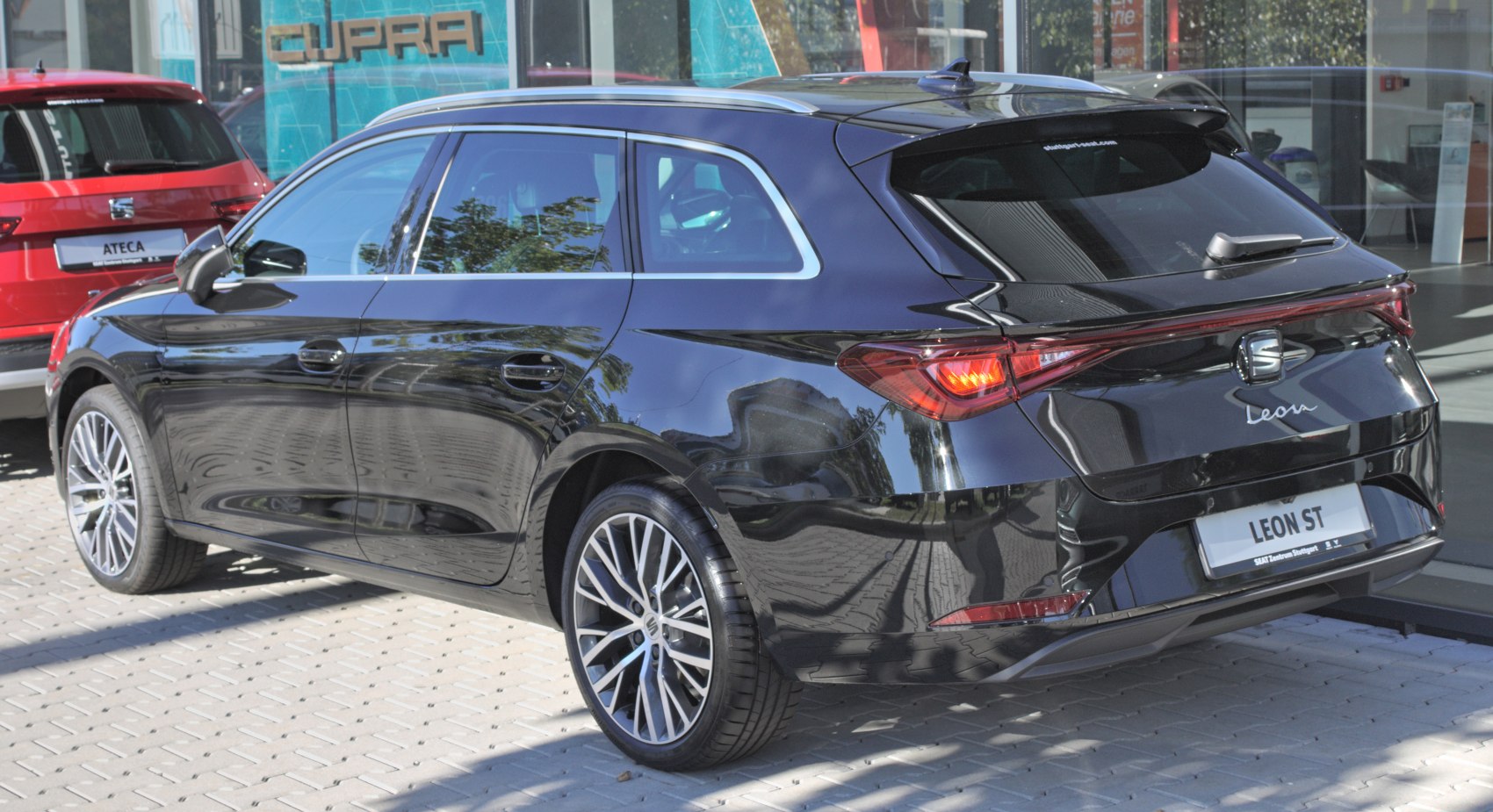 Black modern compact wagon with LED rear lights and multi-spoke wheels