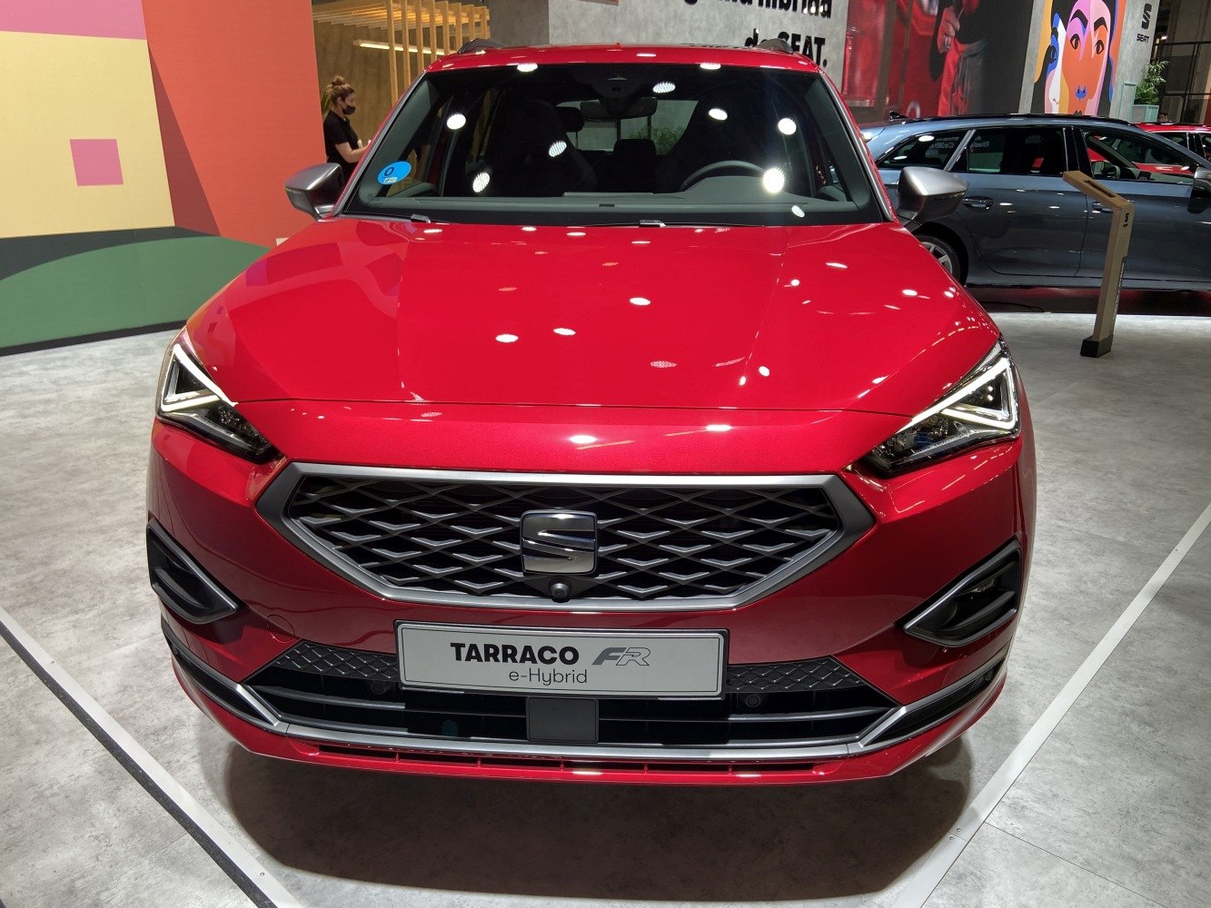 Red modern hatchback with aggressive LED headlights and distinctive grille