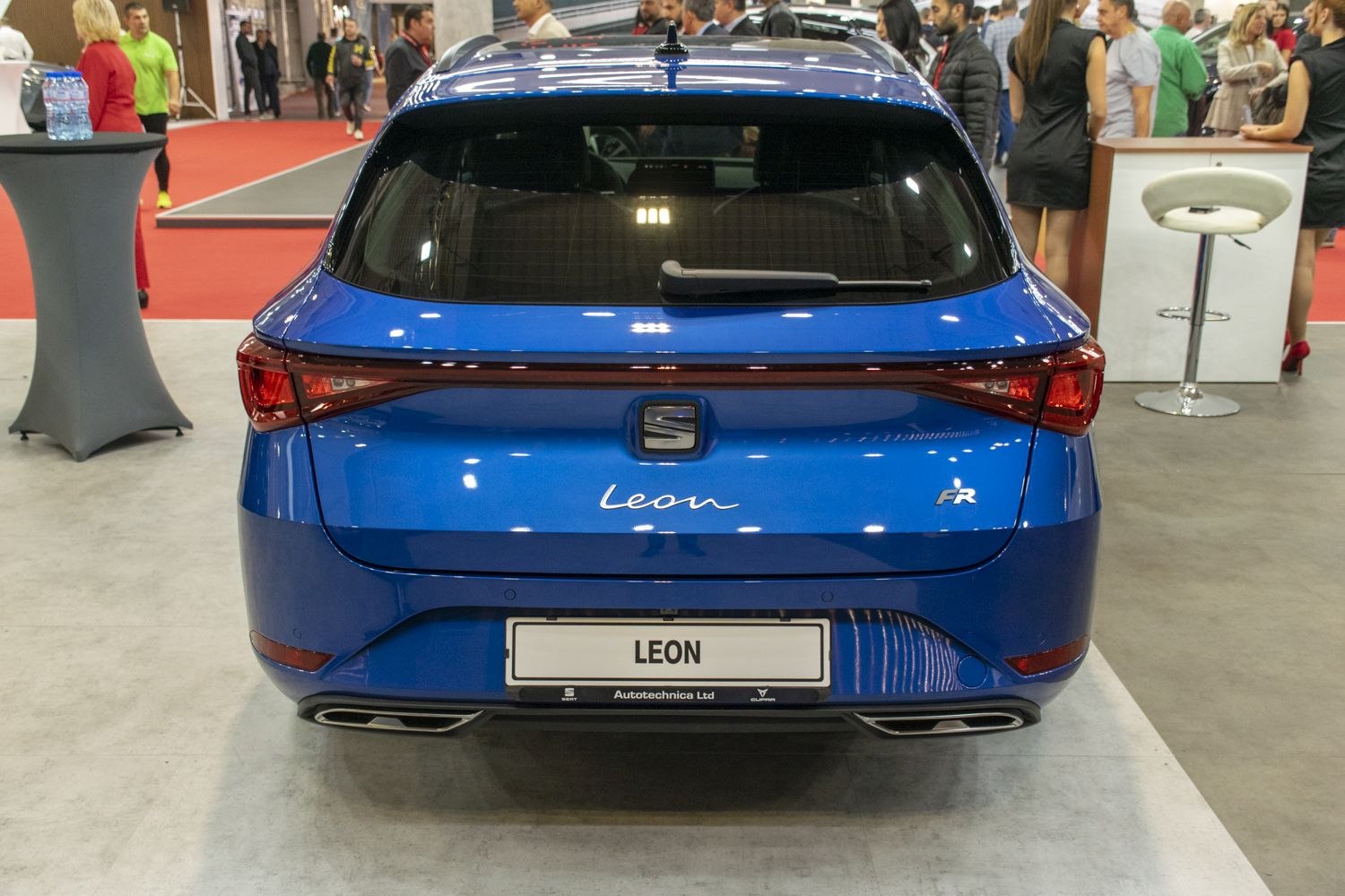 Full-width LED tail lights and dual exhaust outlets in rear view