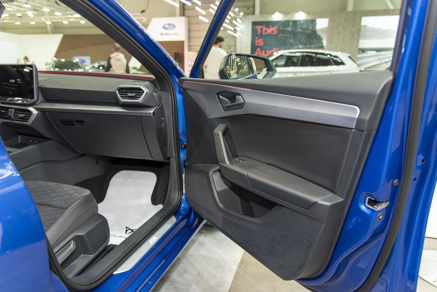 Passenger side door panel and front seat with detailed interior design and upholstery
