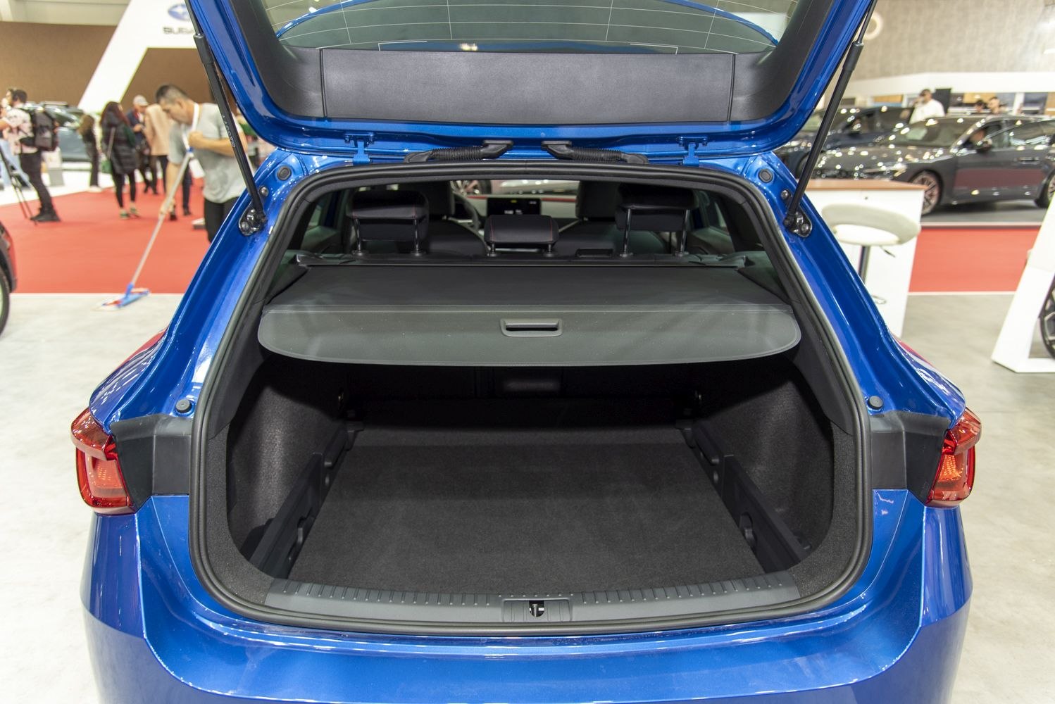 Spacious open trunk with cargo cover on blue hatchback