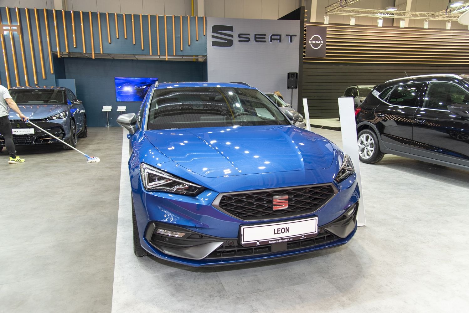 Sharp headlights and wide grille on a sleek hatchback front view