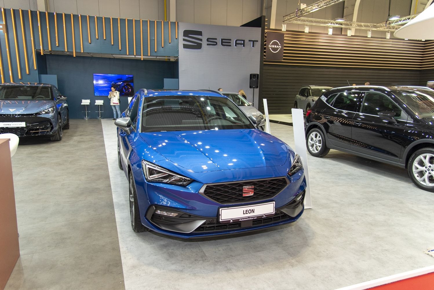 Blue modern hatchback with sharp headlights and hexagonal grille front view